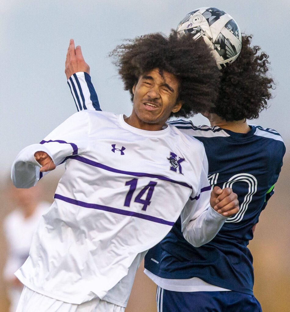 Kamiak’s Saikou Bojang grimaces while jumping in the air for a head ball during the game on Monday, April 1, 2024 in Snohomish, Washington. (Olivia Vanni / The Herald)
