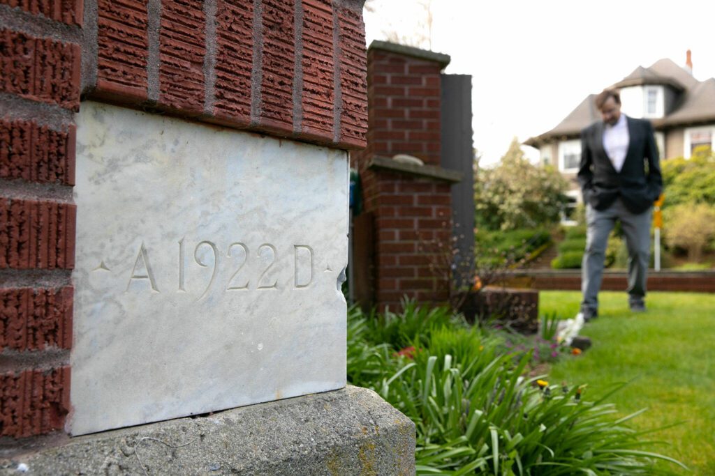 A cornerstone from 1922 is seen on the exterior of the church as Pastor Don Stults stands out front at Zion Lutheran Church on Monday, April 1, 2024, in Snohomish, Washington. (Ryan Berry / The Herald)
