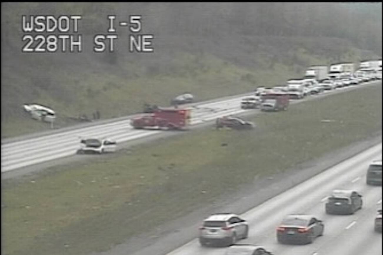 Traffic camera footage shows a crash on northbound I-5 near Arlington that closed all lanes of the highway Monday afternoon. (Washington State Department of Transportation)