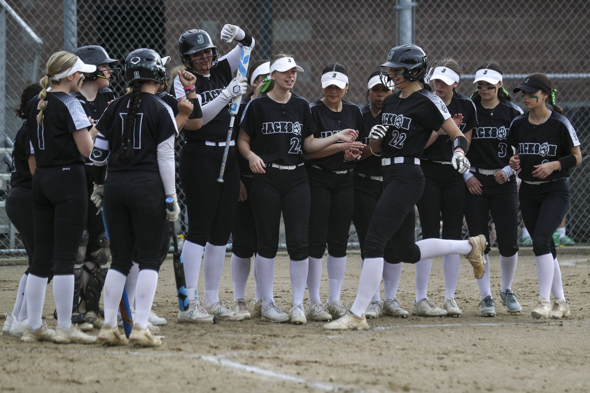 Jackson’s Allie Thomsen (22) celebrates a homerun during a prep softball game between Stanwood and Jackson at Henry M. Jackson High School on Tuesday, April 2, 2024 in Mill Creek, Washington. Jackson won, 6-0. (Annie Barker / The Herald)