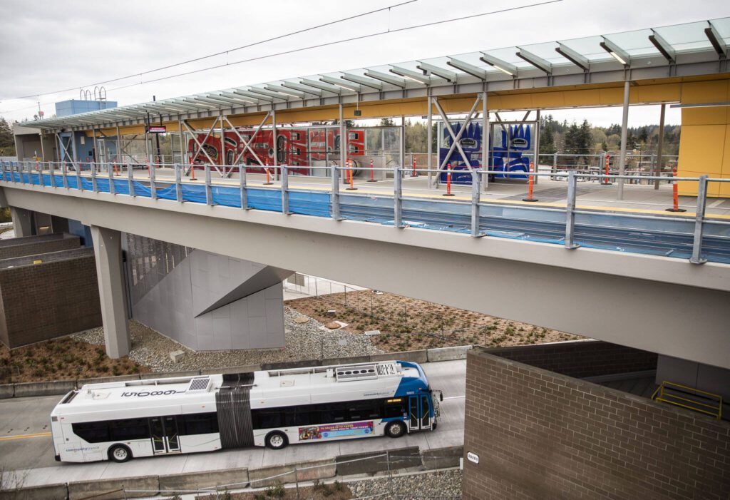 A Community Transit bus drives underneath the Lynnwood Light Rail station on Thursday, April 4, 2024 in Lynnwood, Washington. (Olivia Vanni / The Herald)
