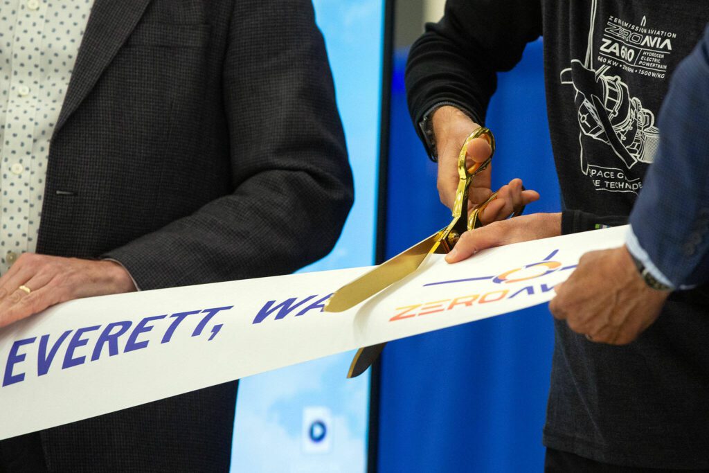 Val Miftakhov cuts the ribbon a second time to remove the ZeroAvia logo during an event at ZeroAvia’s new facility on Wednesday, April 24, 2024, near Paine Field in Everett, Washington. (Ryan Berry / The Herald)
