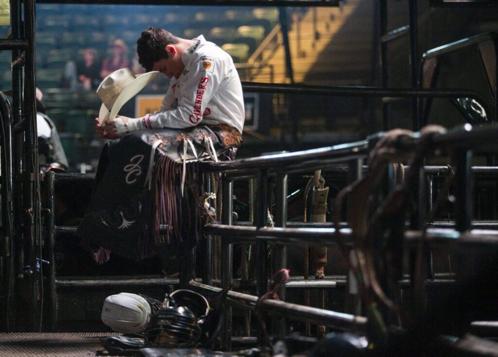 A bull rider takes a moment before the start of PBR Everett at Angel of the Winds Arena on Wednesday, April 17, 2024 in Everett, Washington. (Olivia Vanni / The Herald)
