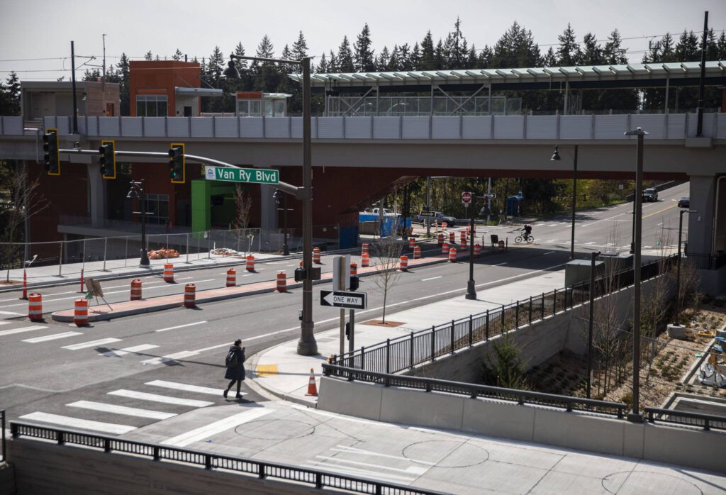 Pedestrians and bicyclists cross the street next to the new Mountlake Terrace Link station on Wednesday, April 10, 2024 in Mountlake Terrace, Washington. (Olivia Vanni / The Herald)
