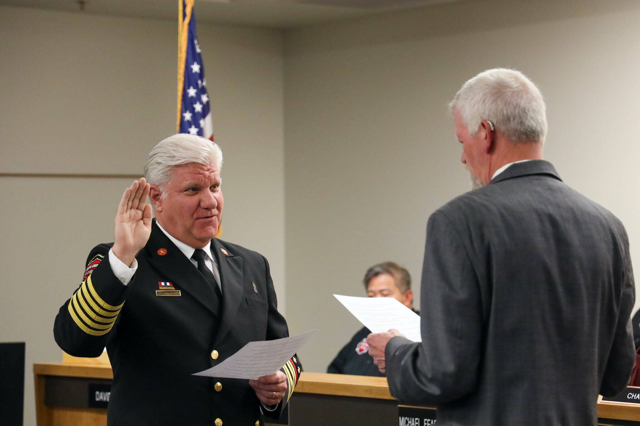 South County Fire Commissioner Ed Widdis, right, swears in Fire Chief Bob Eastman on April 2, 2024. (Photo provided by South County Fire).