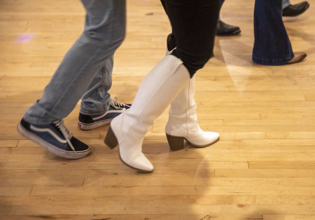 People go through dance steps during country dance lessons at Normanna Lodge on Tuesday, April 9, 2024 in Everett, Washington. (Olivia Vanni / The Herald)
