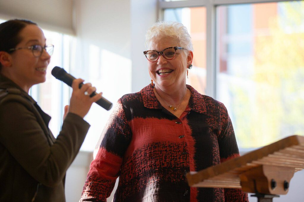 Kathy Solberg, former CEO of Leadership Snohomish County, comes up to the lectern during the 2024 Snohomish County Emerging Leaders Awards Presentation on Wednesday, April 17, 2024, in Everett, Washington. (Ryan Berry / The Herald)

