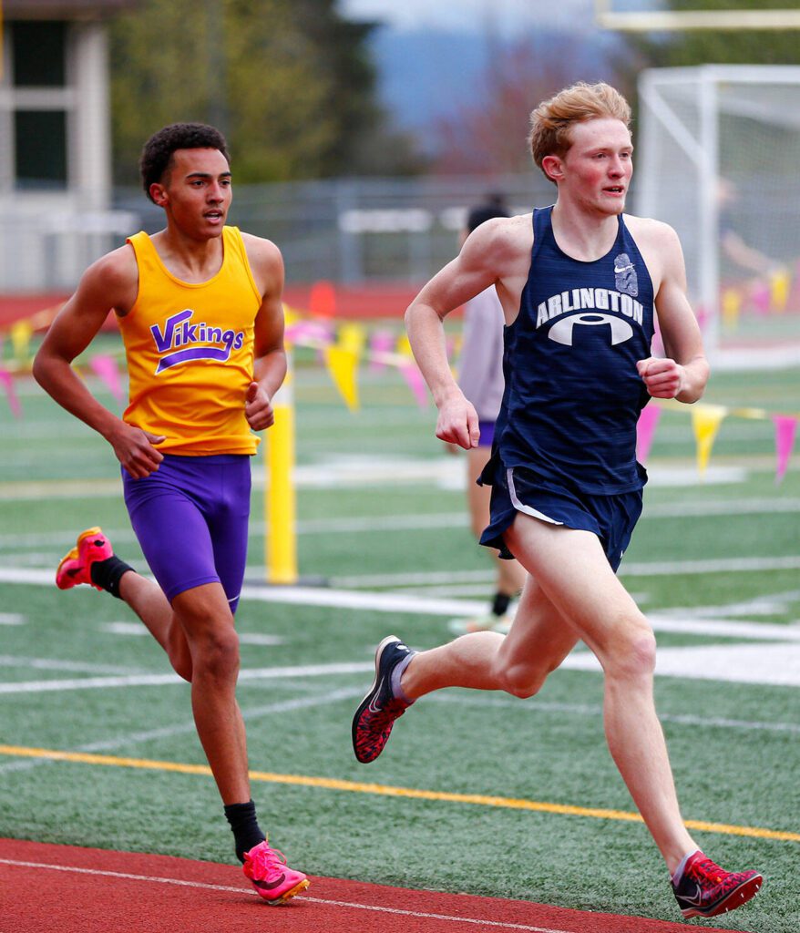 Lake Stevens’ Ares Van Straaten keeps close to Arlington’s Lucas Spurling in the 1600 during a meet Thursday, April 11, 2024, in Lake Stevens, Washington. Van Straaten won the race and claimed a PR along with Spurling. (Ryan Berry / The Herald)
