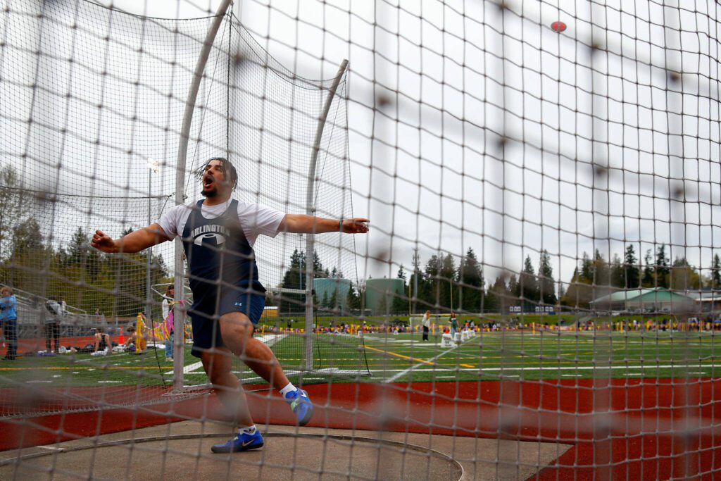 Arlington’s Hayden Falor throws in the discus during a meet Thursday, April 11, 2024, in Lake Stevens, Washington. (Ryan Berry / The Herald)
