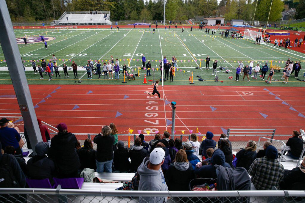 Arlington sprinter Dallas Miller leaves the competition in the dust while winning the 400 meter dash during a meet Thursday, April 11, 2024, in Lake Stevens, Washington. (Ryan Berry / The Herald)
