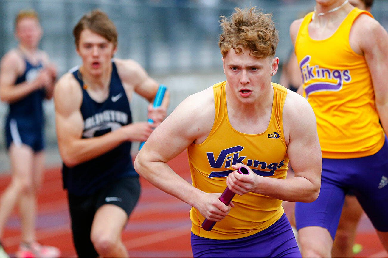Lake Stevens’ Jesse Lewis takes the handoff as the anchor in the 4x400 during a meet Thursday, April 11, 2024, in Lake Stevens, Washington. (Ryan Berry / The Herald)