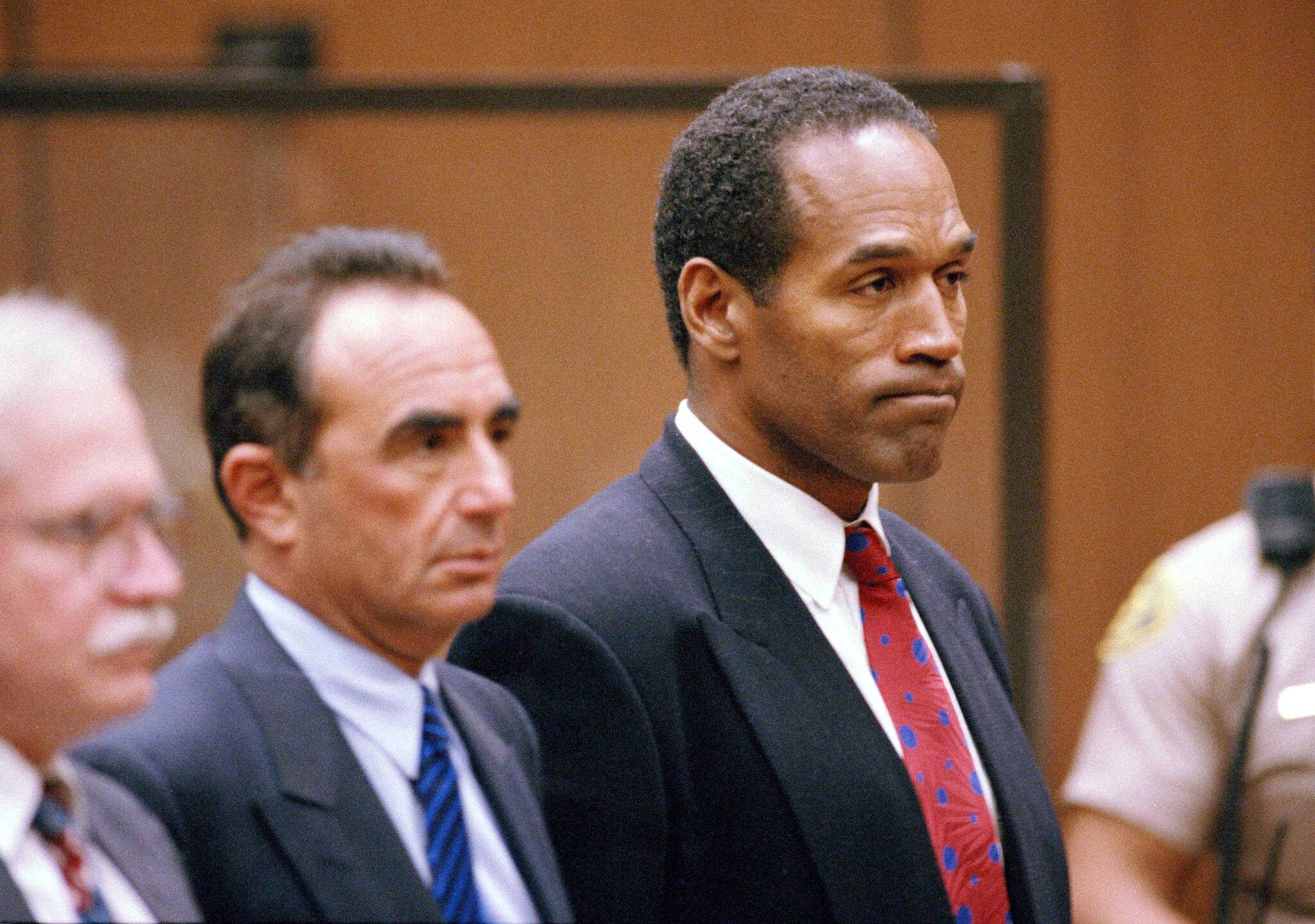 O.J. Simpson stands as he listens to Municipal Judge Kathleen Kennedy-Powell as she reads her decision to hold him over for trial on July 8, 1994, in connection with the June 12 slayings of his ex-wife Nicole Brown Simpson and Ronald Goldman. Simpson, the decorated football superstar and Hollywood actor who was acquitted of charges he killed his former wife and her friend but later found liable in a separate civil trial, has died. He was 76. (AP Photo/Eric Draper, Pool, File)