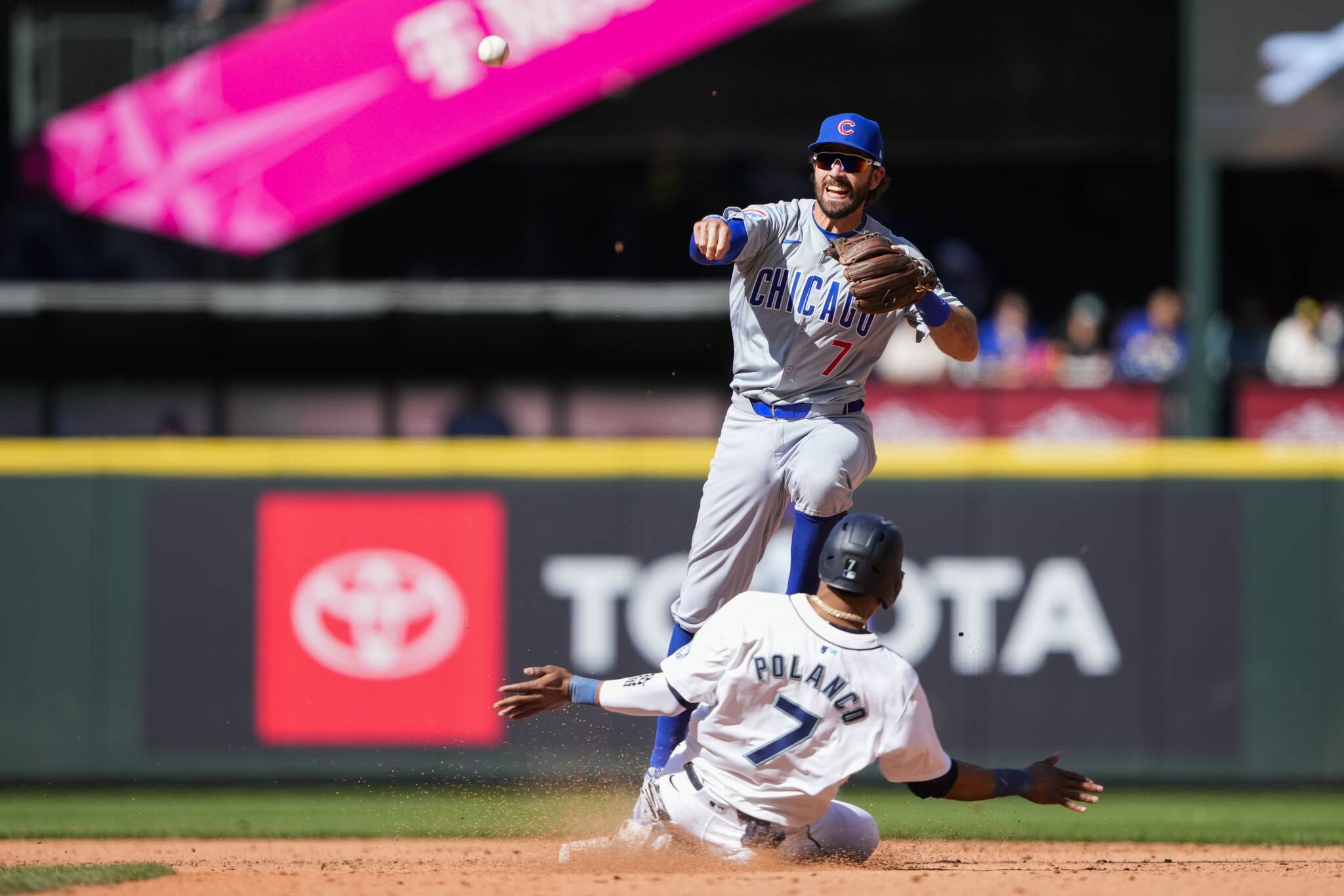 Chicago Cubs shortstop Dansby Swanson, top, forces out the Seattle Mariners’ Jorge Polanco (7) at second base and makes the throw to first for the double play against Mariners’ Ty France to end the eighth inning of Sunday’s game in Seattle. (AP Photo/Lindsey Wasson)