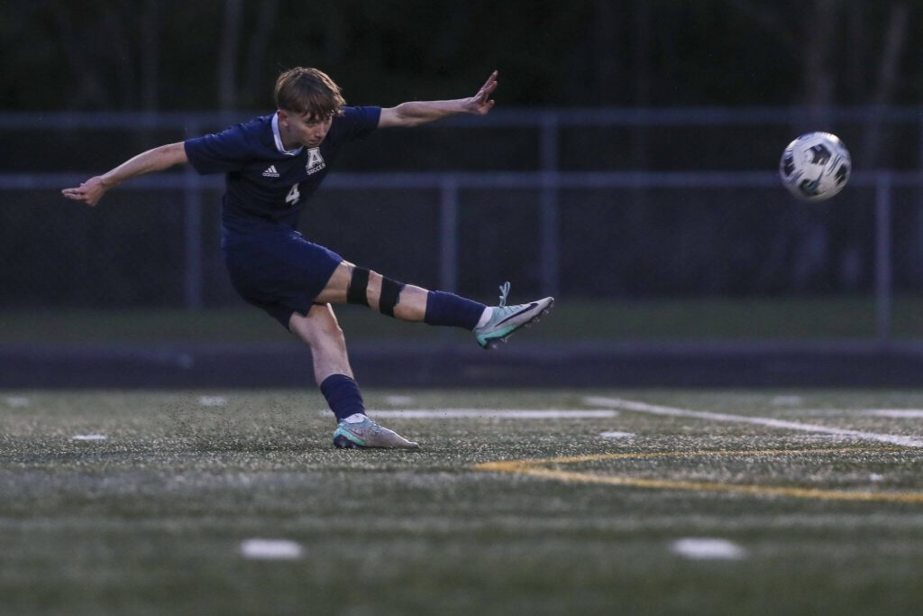 Arlington’s Cameron Payne (4) kicks the ball during a boys soccer game between Archbishop Murphy and Arlington at Arlington High School on Monday, April 15, 2024 in Arlington, Washington. (Annie Barker / The Herald)
