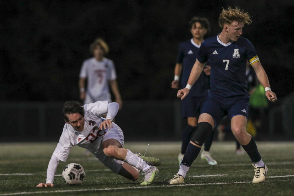 Archbishop Murphy’s Paul Holeman (22) trips fighting for the ball during a boys soccer game between Archbishop Murphy and Arlington at Arlington High School on Monday, April 15, 2024 in Arlington, Washington. (Annie Barker / The Herald)
