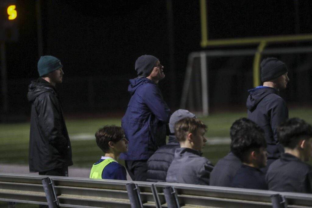 Left to right, coaches Liam Raney, Matt Raney, and Kieren Raney watch during a boys soccer game between Archbishop Murphy and Arlington at Arlington High School on Monday, April 15, 2024 in Arlington, Washington. (Annie Barker / The Herald)
