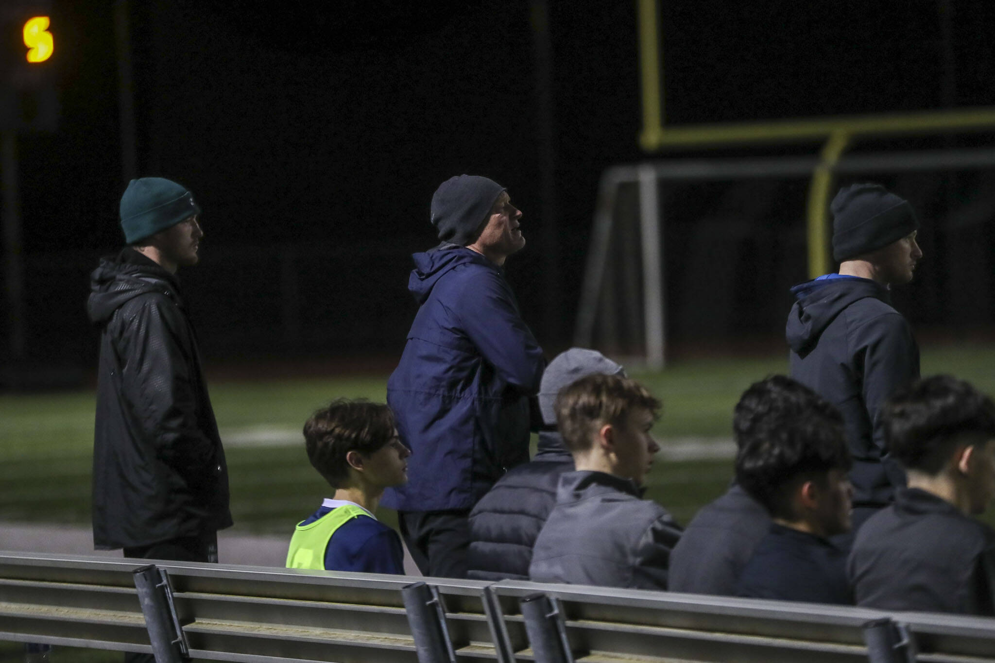 Left to right, coaches Liam Raney, Matt Raney, and Kieren Raney watch during a boys soccer game between Archbishop Murphy and Arlington at Arlington High School on Monday, April 15, 2024 in Arlington, Washington. (Annie Barker / The Herald)