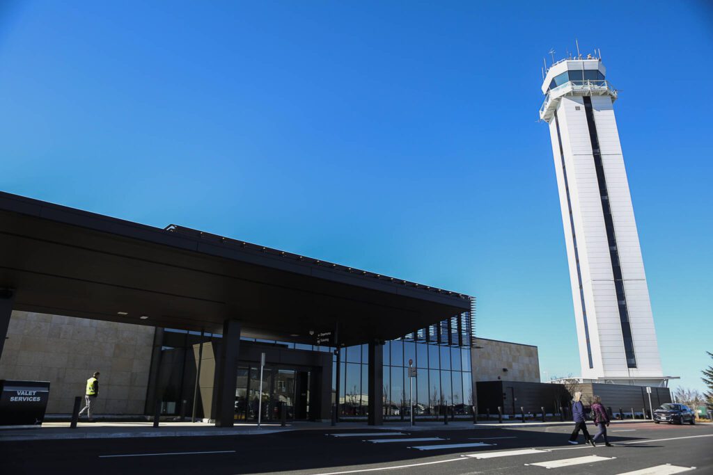 People arrive at the entrance to the terminal during the grand-opening of the Paine Field Airport on Monday, March 4, 2019 in Everett, Wash. (Olivia Vanni / The Herald)
