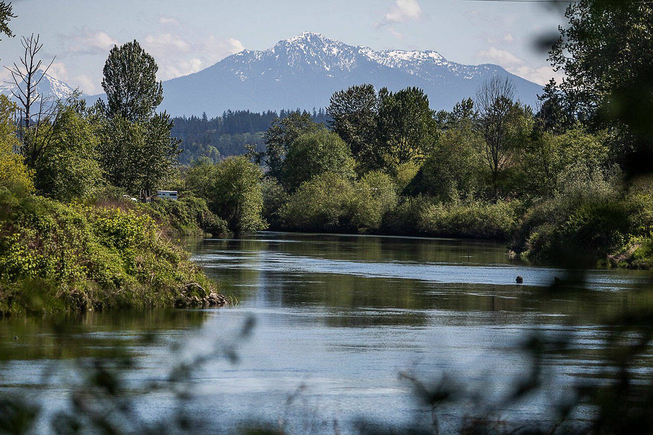 Snow is visible along the top of Mount Pilchuck from bank of the Snohomish River on Wednesday, May 10, 2023 in Everett, Washington. (Olivia Vanni / The Herald)