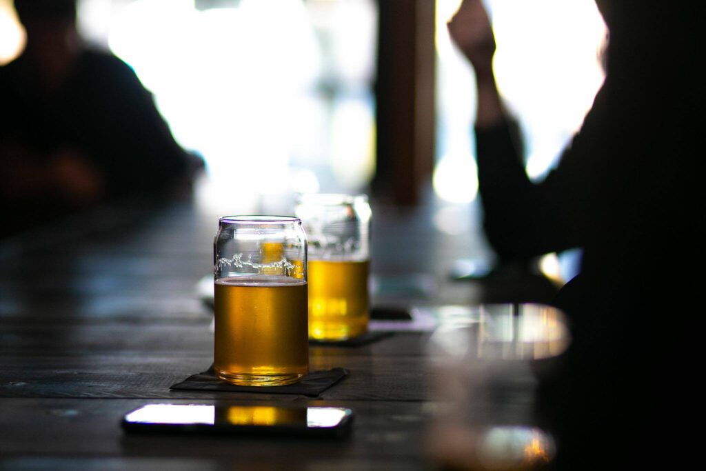 Beer is served in can-shaped glasses at Obsidian Beer Hall on Friday, April 12, 2024, in downtown Everett, Washington. (Ryan Berry / The Herald) 
