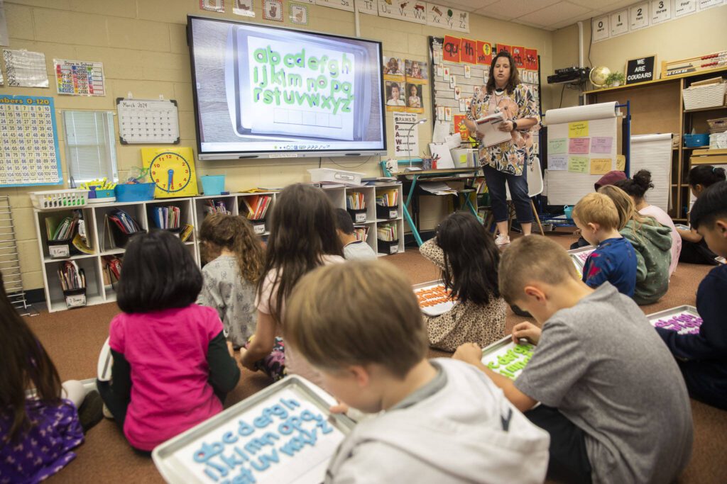 Kimberly Hildenbrand runs through a spelling exercise with her first grade class on the classroom’s Boxlight interactive display board funded by a previous tech levy on Tuesday, March 19, 2024, in the Lakewood School District. (Olivia Vanni / The Herald)

