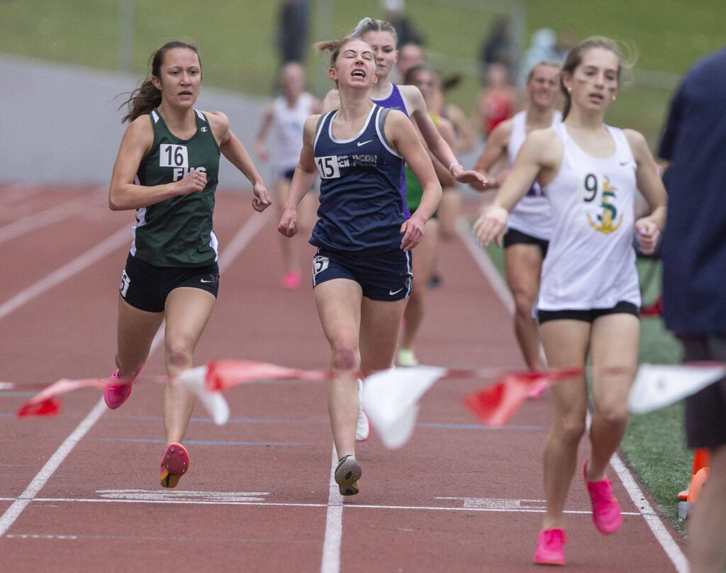 Glacier Peak’s Clara Diepenbrock grimaces as she crosses the finish line in the girls 1,600 metera during the Eason Invitational at Snohomish High School on Saturday, April 20, 2024 in Snohomish, Washington. (Olivia Vanni / The Herald)
