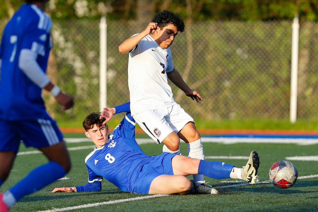 Shorewood’s Nikola Genadiev tackles the ball away from Cascade’s Asios Corona Martinez during a boys soccer match on Monday, April 22, 2024, at Shoreline Stadium in Shoreline, Washington. (Ryan Berry / The Herald)
