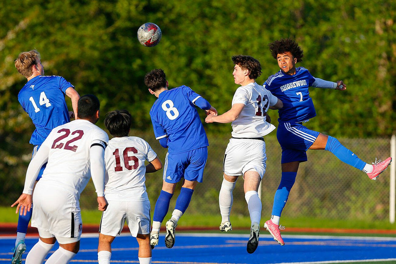 Shorewood and Cascade players all jump for a set piece during a boys soccer match on Monday, April 22, 2024, at Shoreline Stadium in Shoreline, Washington. (Ryan Berry / The Herald)