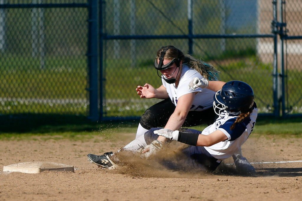 Lake Stevens third baseman Emerson Cummins tags out a runner on a great throw from McKenna Richer against Glacier Peak on Tuesday, April 23, 2024, at Glacier Peak High School in Snohomish, Washington. (Ryan Berry / The Herald)
