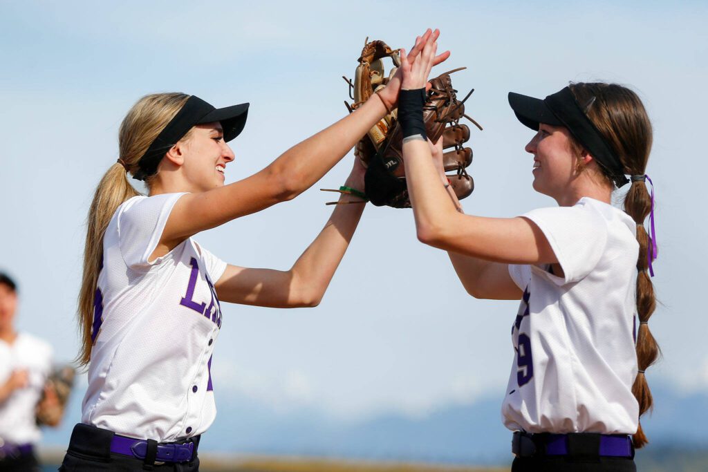 Lake Stevens pitcher Charli Pugmire high fives first baseman Emery Fletcher after getting out of an inning against Glacier Peak on Tuesday, April 23, 2024, at Glacier Peak High School in Snohomish, Washington. (Ryan Berry / The Herald)
