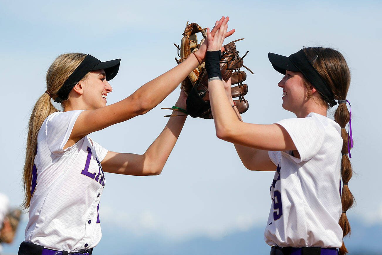 Lake Stevens pitcher Charli Pugmire high fives first baseman Emery Fletcher after getting out of an inning against Glacier Peak on Tuesday, April 23, 2024, at Glacier Peak High School in Snohomish, Washington. (Ryan Berry / The Herald)