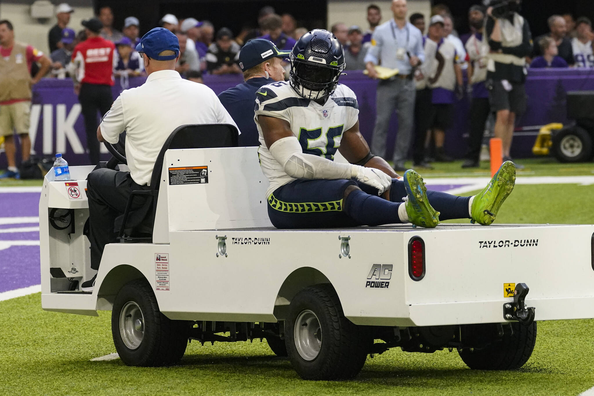 Seattle Seahawks linebacker Jordyn Brooks (56) is taken off the field after being injured in the second half of an NFL football game against the Minnesota Vikings in Minneapolis, Sunday, Sept. 26, 2021. The former first-round pick is an example of the Seahawks failing to find difference makers in recent NFL drafts. (AP Photo/Jim Mone)