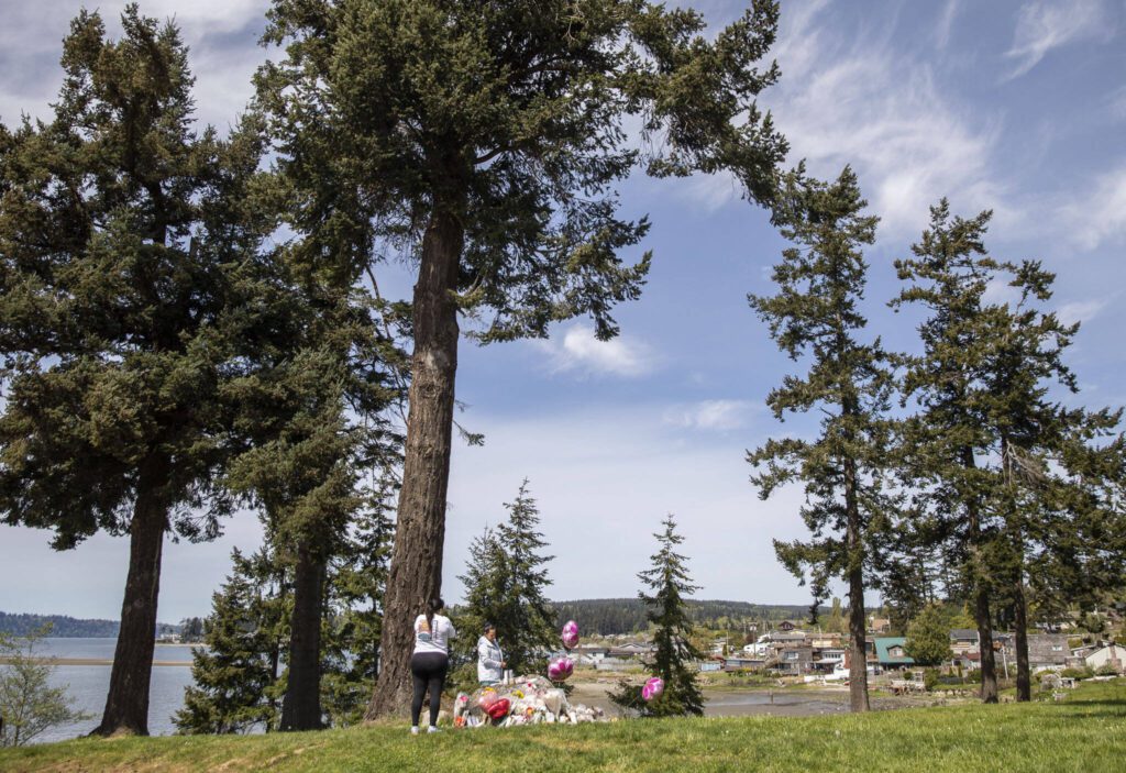 People read notes left at a memorial for Jenzele Couassi outside of the Don Hatch Youth Center on Tuesday, April 23, 2024 in Tulalip, Washington. (Olivia Vanni / The Herald)
