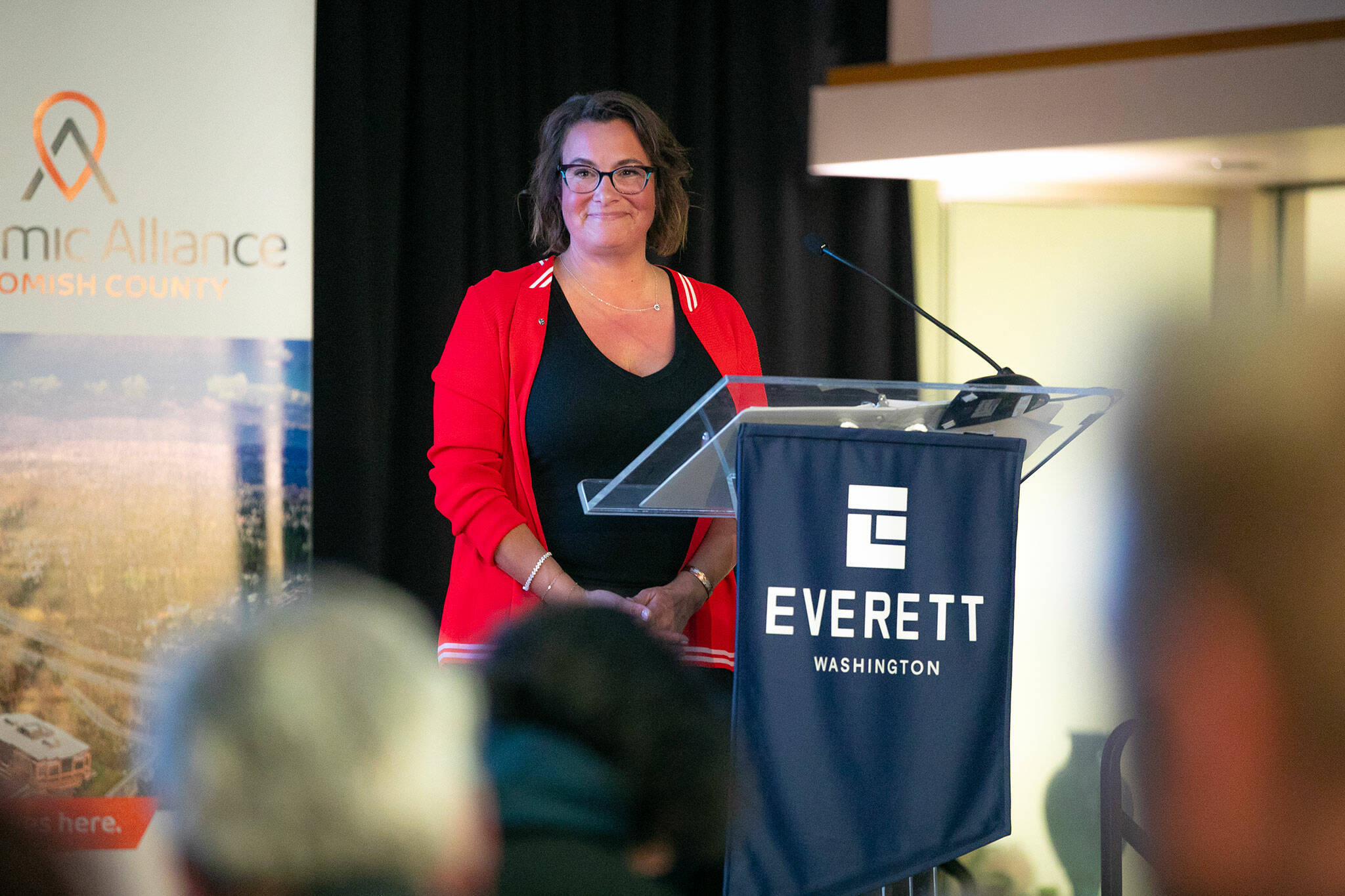Everett Mayor Cassie Franklin steps back and takes in a standing ovation after delivering the State of the City Address on Thursday, March 21, 2024, at the Everett Mall in Everett, Washington. (Ryan Berry / The Herald)