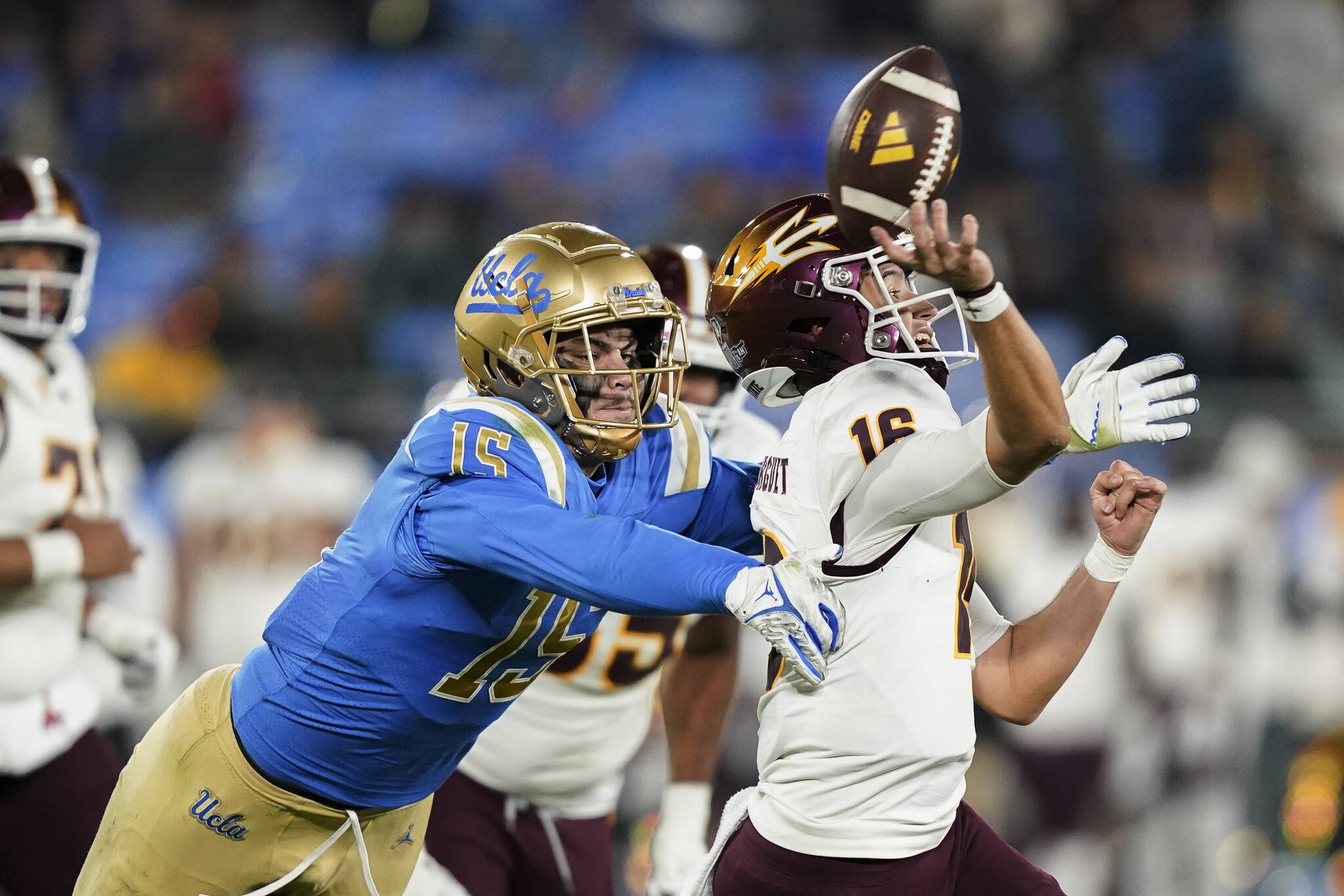 UCLA pass rusher Laiatu Latu, left, pressures Arizona State quarterback Trenton Bourguet during the second half of an NCAA college football game Nov. 11, 2023, in Pasadena, Calif. Latu is the type of player the Seattle Seahawks may target with their first-round pick in the NFL draft. (AP Photo/Ryan Sun, File)