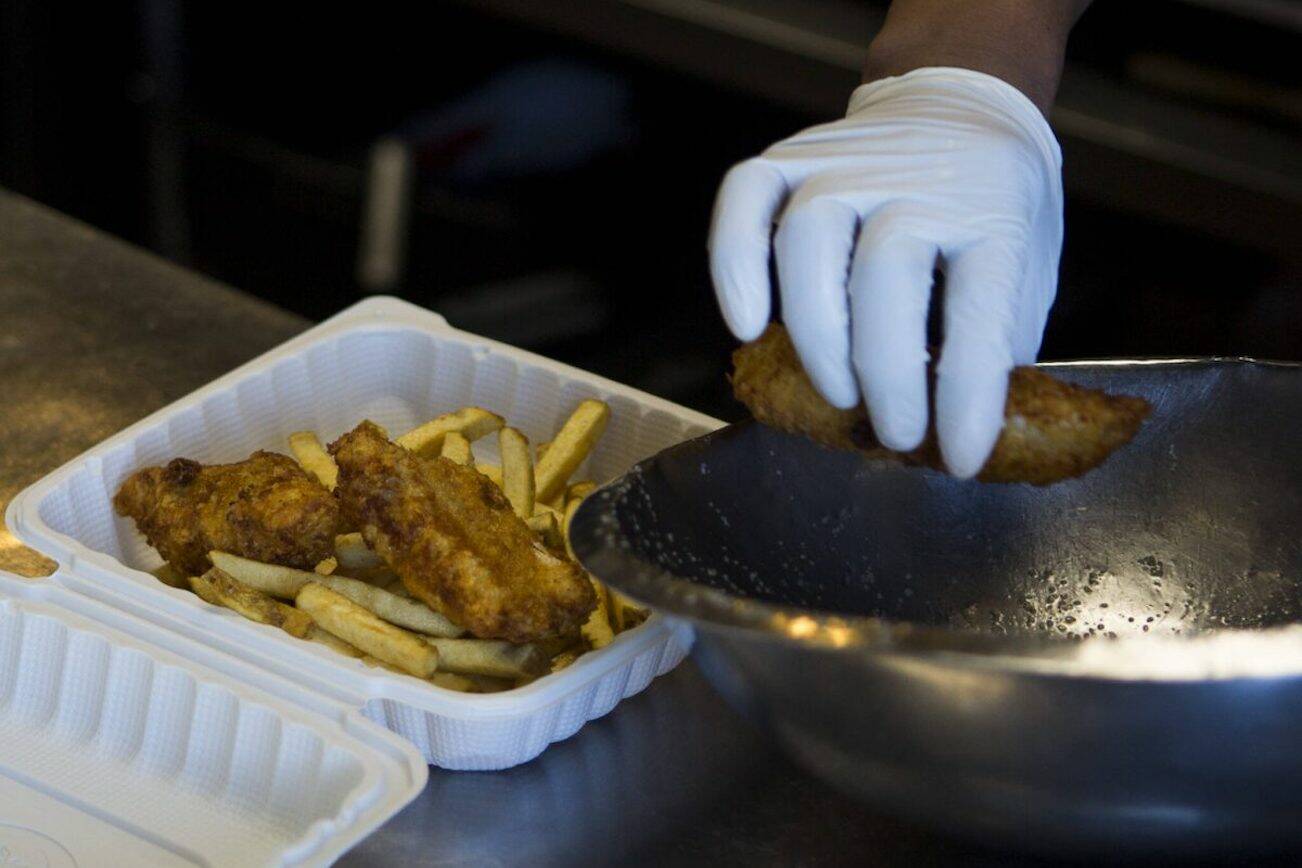 Andy's Fish House cooks put together a three piece fish and chips order on Thursday, March 19, 2020 in Snohomish, Wa. (Olivia Vanni / The Herald)
