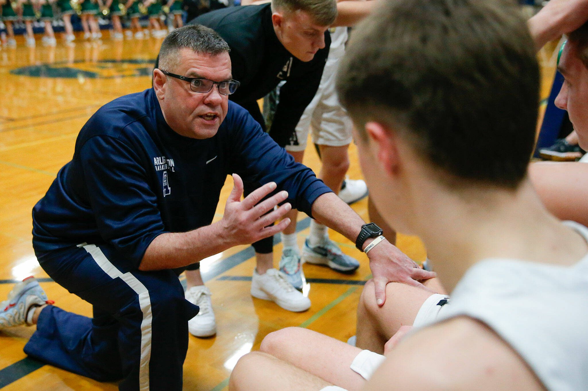 Arlington head coach Nick Brown talks with his team during a time-out against Marysville Getchell during a playoff matchup at Arlington High School on Saturday, Feb. 24, 2024, in Arlington, Washington. (Ryan Berry / The Herald)