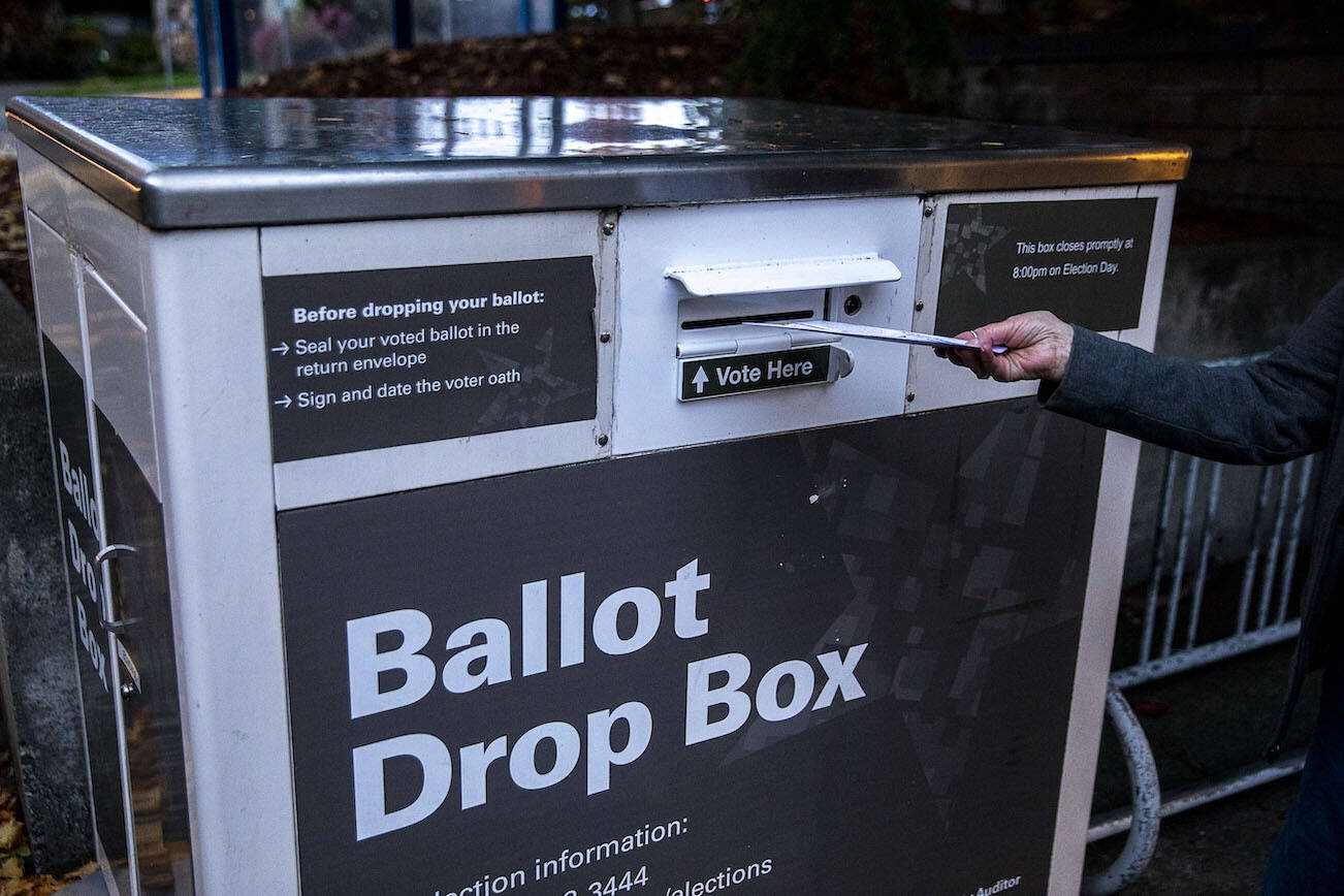 A person turns in their ballot at a ballot box located near the Edmonds Library in Edmonds, Washington on Sunday, Nov. 5, 2023. (Annie Barker / The Herald)