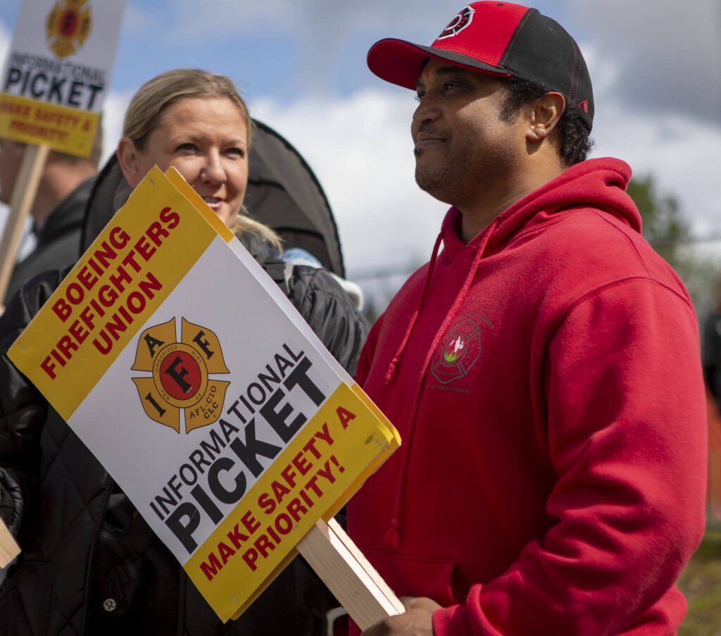Tony Coleman participates in the Boeing firefighter union’s informational picket at Airport Road and Kasch Park Road on Monday, April 29, 2024 in Everett, Washington. (Annie Barker / The Herald)
