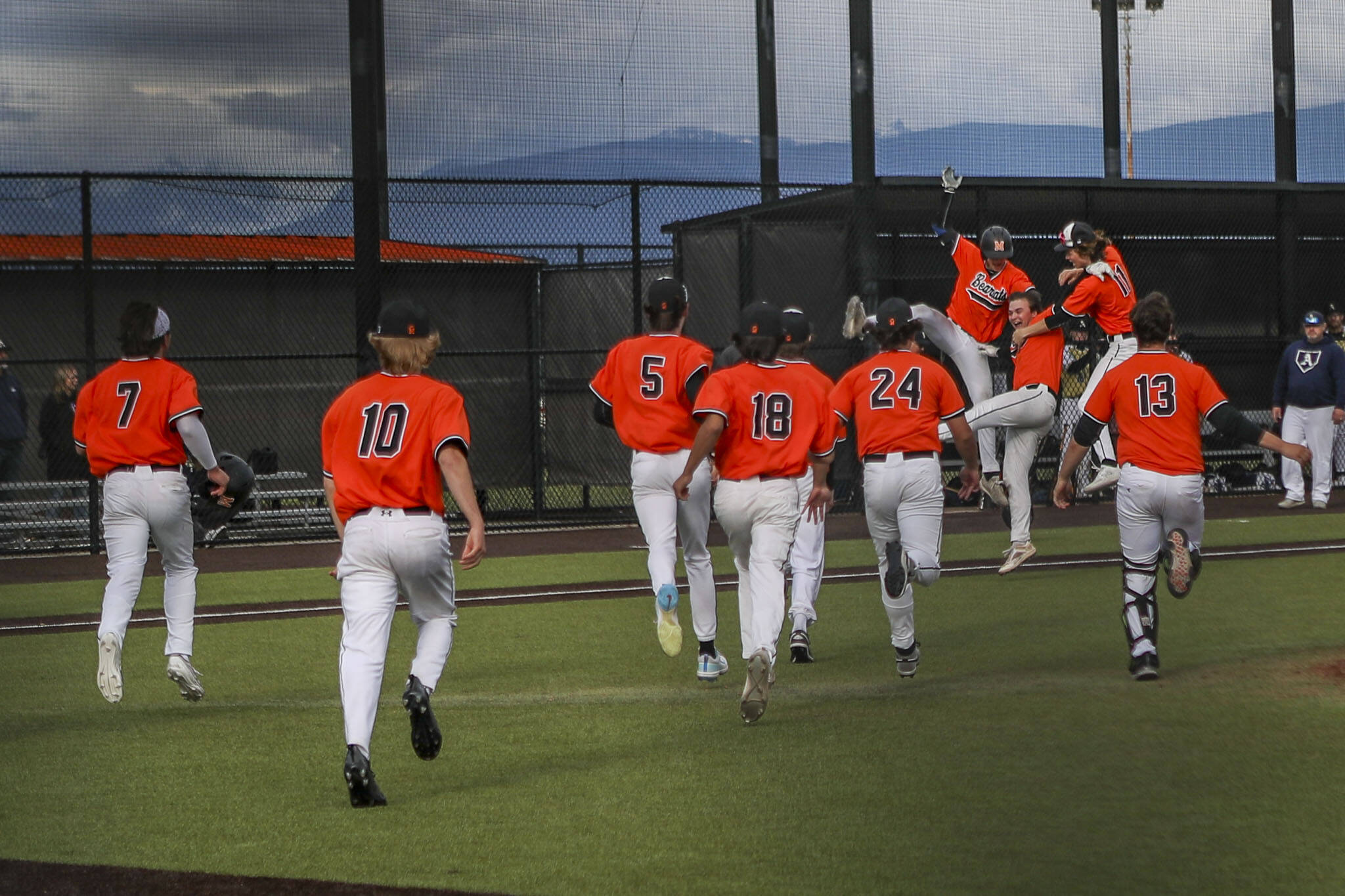 Monroe players celebrate during a baseball game between Monroe and Arlington at Monroe High School on Friday, April 26, 2024 in Monroe, Washington. Monroe secured a win in an eighth inning, 4-3. (Annie Barker / The Herald)