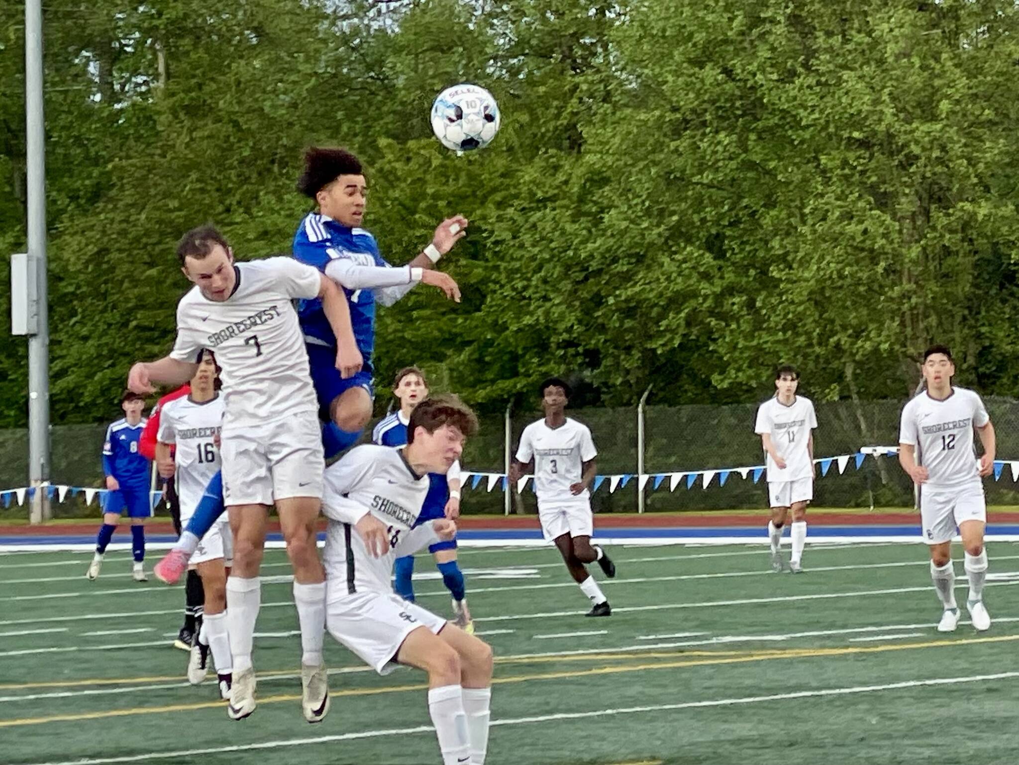 Shorewood’s Jackson Smith attempts a header shot over Shorecrest defenders Porter Lewis and Lachlan Wandler in Monday’s Wesco 3A/2A game at Shoreline Stadium. (Aaron Coe / The Herald)