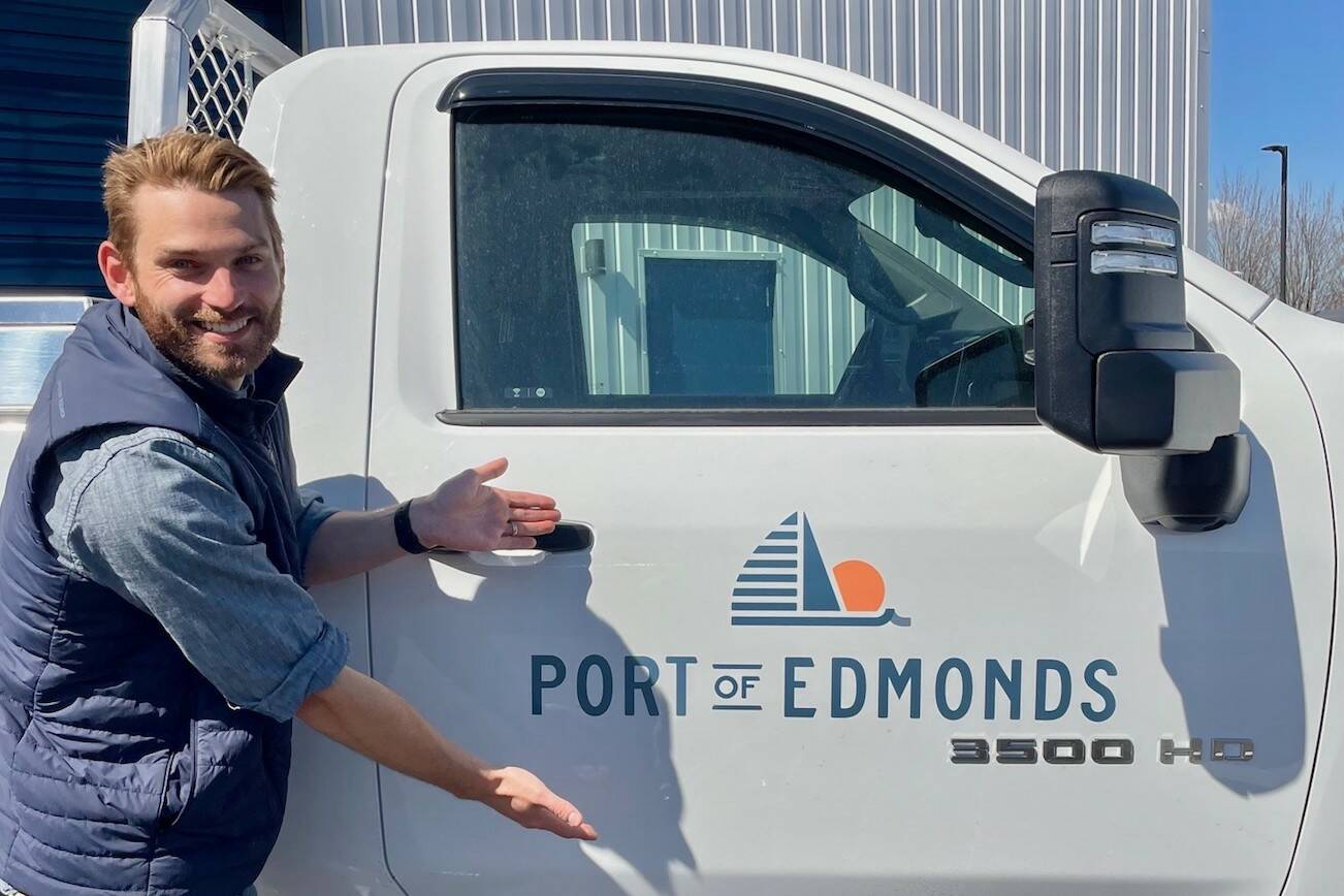 Brandon Baker, deputy director for the Port of Edmonds, shows off the port's new logo. Credit: Port of Edmonds