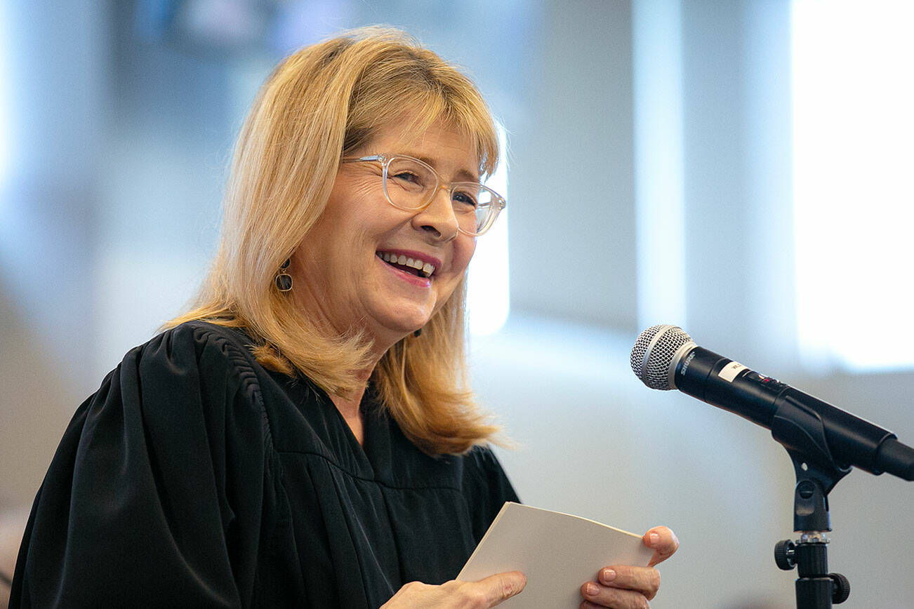 Retired Snohomish County Superior Court Judge Anita Farris smiles as she speaks to a large crowd during the swearing-in of her replacement on the bench, Judge Whitney M. Rivera, on Thursday, May 9, 2024, at Snohomish County Superior Court in Everett, Washington. (Ryan Berry / The Herald)