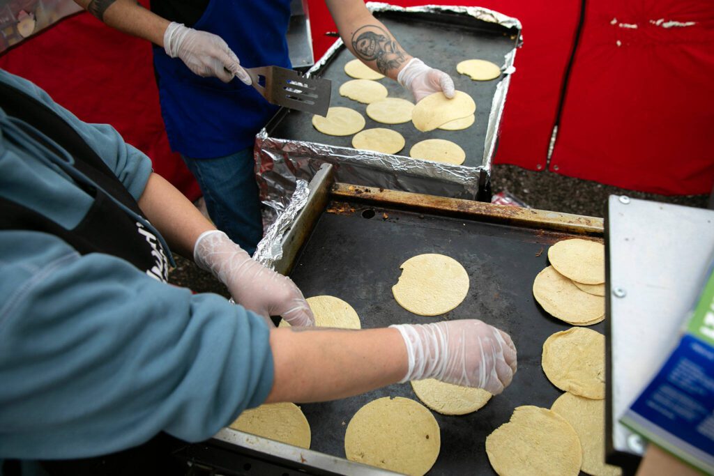 Babacoa Judith’s makes fresh tortillas for their lamb tacos at the Hidden Gems Weekend Market on Sunday, April 28, 2024, at Boom City in Tulalip, Washington. (Ryan Berry / The Herald)
