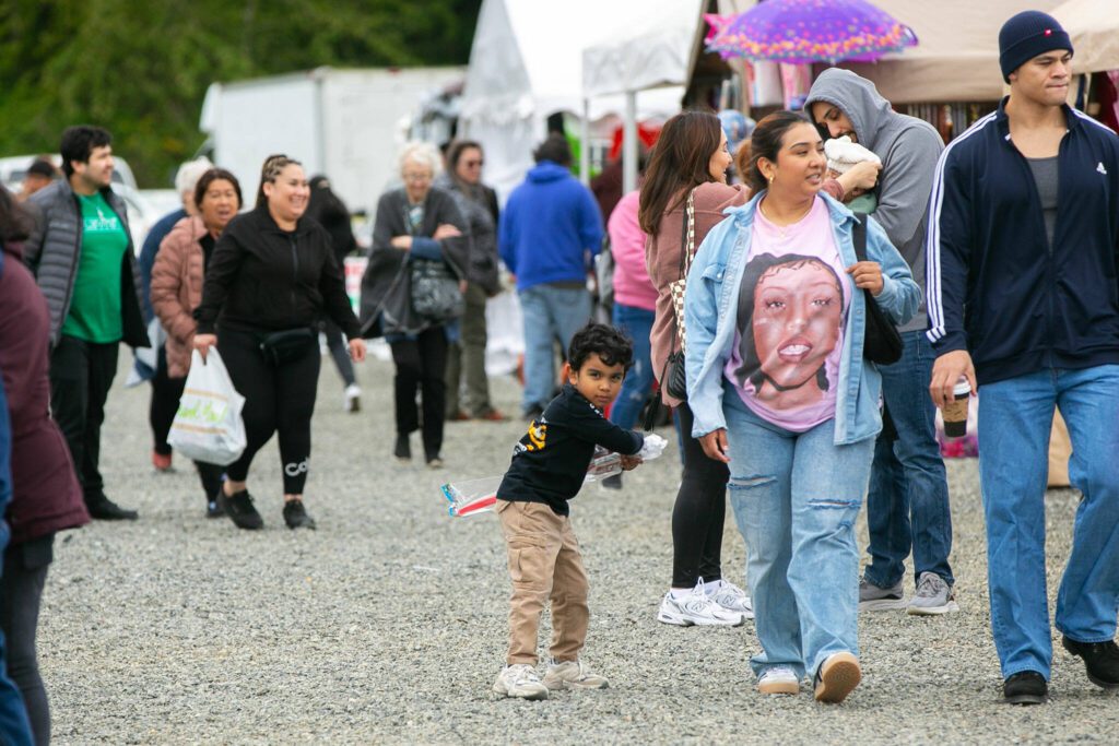 A young boy tests his swordsmanship while following family around the Hidden Gems Weekend Market on Sunday, April 28, 2024, at Boom City in Tulalip, Washington. (Ryan Berry / The Herald)
