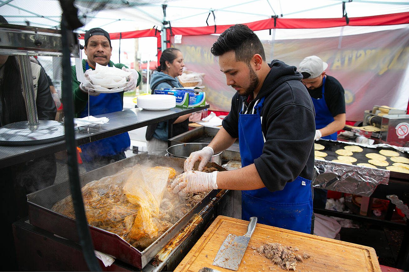 Pablo Garduno and the team at Barbacoa Judith’s churn out pit-roasted lamb tacos by the dozen at the Hidden Gems Weekend Market on Sunday, April 28, 2024, at Boom City in Tulalip, Washington. (Ryan Berry / The Herald)