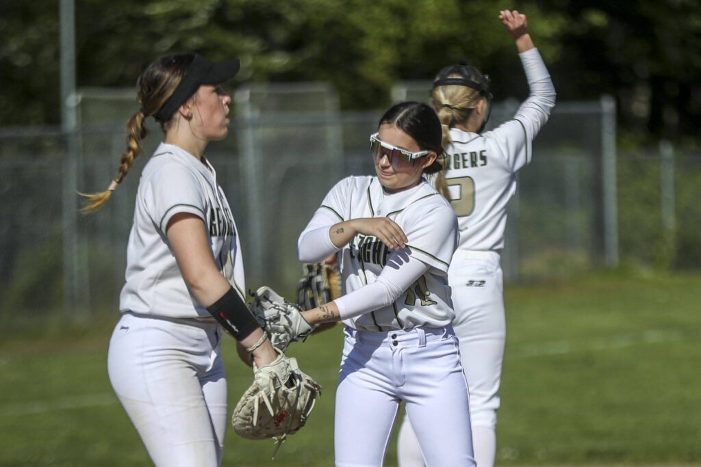 Marysville Getchell players huddle during a softball game between Meadowdale and Marysville Getchell on Wednesday, May 1, 2024 in Marysville, Washington. Meadowdale won, 12-9. (Annie Barker / The Herald)
