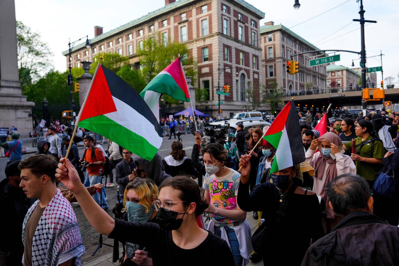 Pro-Palestinian protesters, barred from entering the campus, rally outside Columbia University in upper Manhattan on Tuesday, April 30, 2024.  Police later swept onto the campus to clear protesters occupying Hamilton Hall. (Amir Hamja/The New York Times)