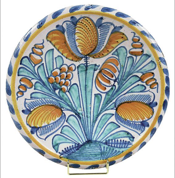 This delftware charger was made in 17th-century England. Bright, colorful flowers never go out of style, especially in spring.