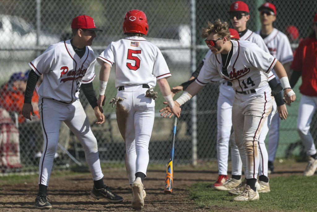 Snohomish players celebrate a run during a District 1 3A baseball game between Meadowdale and Snohomish at Snohomish High School on Monday, April 30, 2024 in Snohomish, Washington. Snohomish won, 3-1. (Annie Barker / The Herald)
